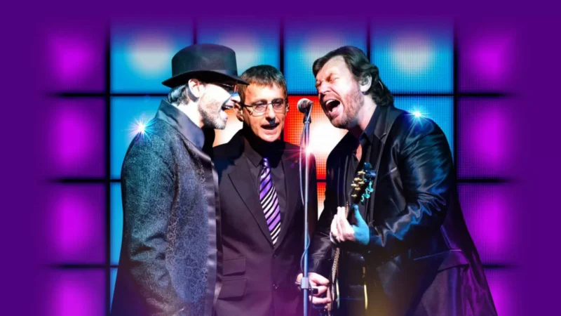 Performers from The Australian Bee Gees Show singing on stage during a live tribute concert in Las Vegas