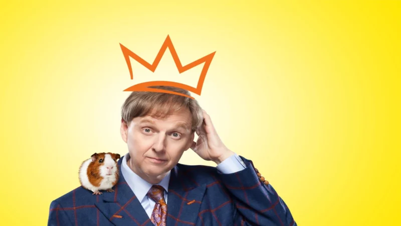 Mac King performing comedy magic with a guinea pig during his family-friendly Las Vegas show