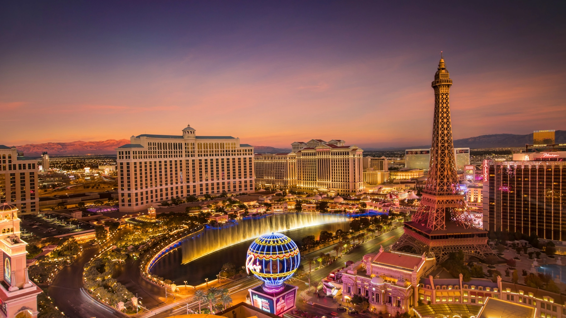 Bellagio Fountains and Paris Las Vegas Eiffel Tower at sunset on the Las Vegas Strip