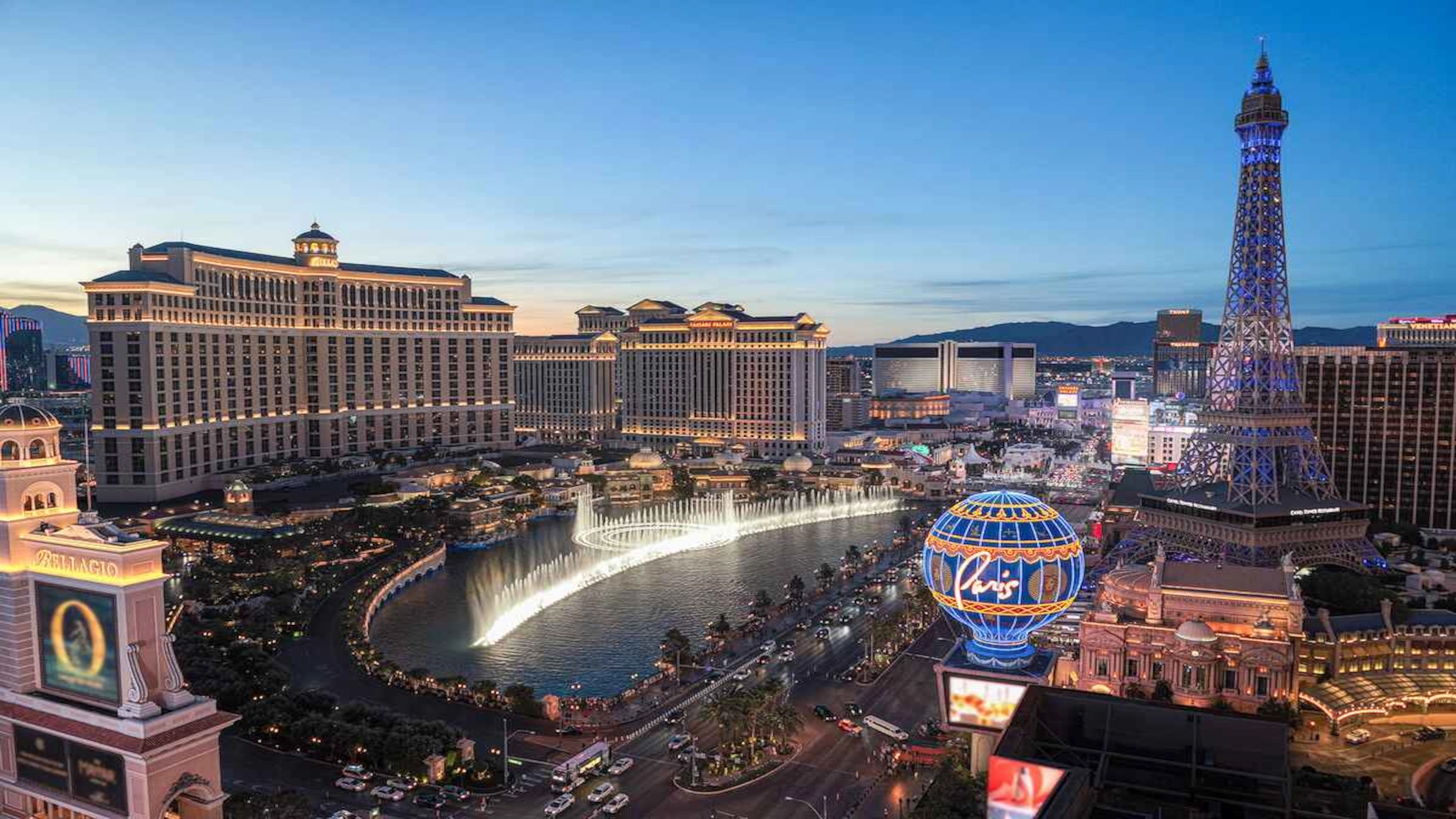 Bellagio fountains and central Las Vegas Strip skyline at dusk
