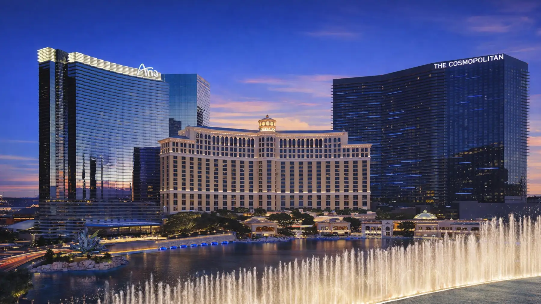 ARIA, Bellagio, and Cosmopolitan hotels on the Las Vegas Strip at night with Bellagio fountains