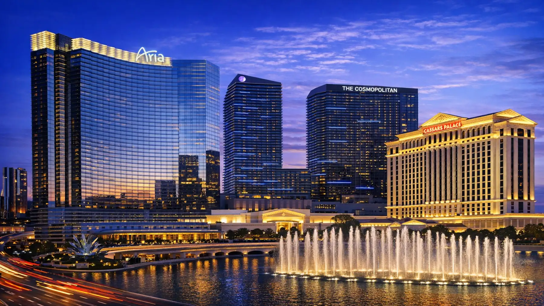 ARIA, Cosmopolitan, and Caesars Palace on the Las Vegas Strip at night with fountains in the foreground